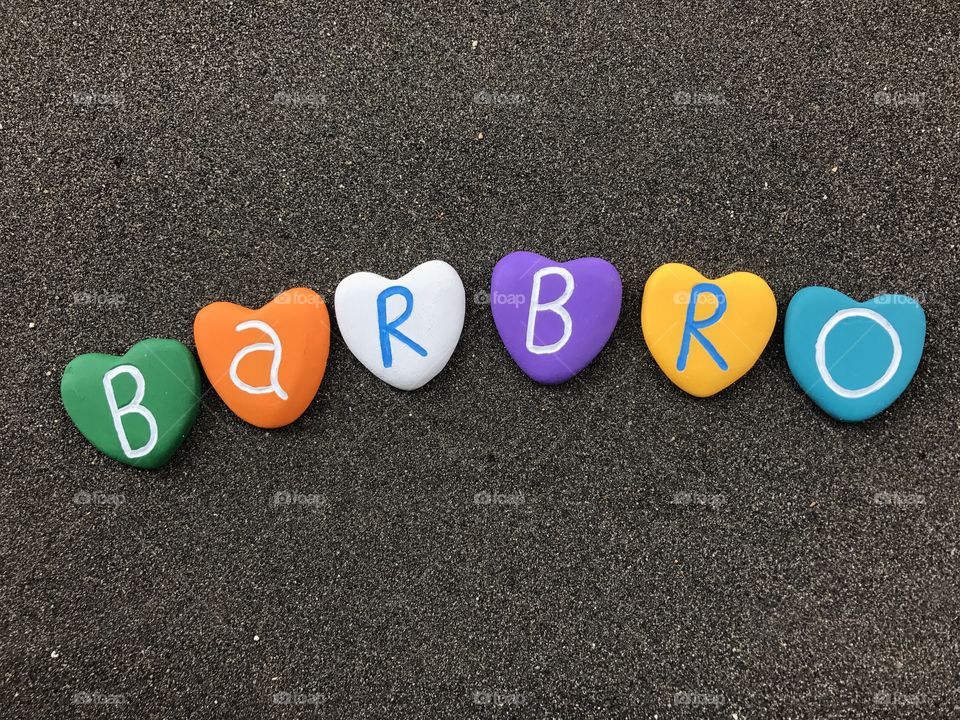Barbro, female scandinavian name with colored heart stones over black volcanic sand