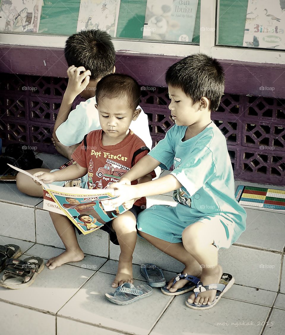 Group of children studying on steps
