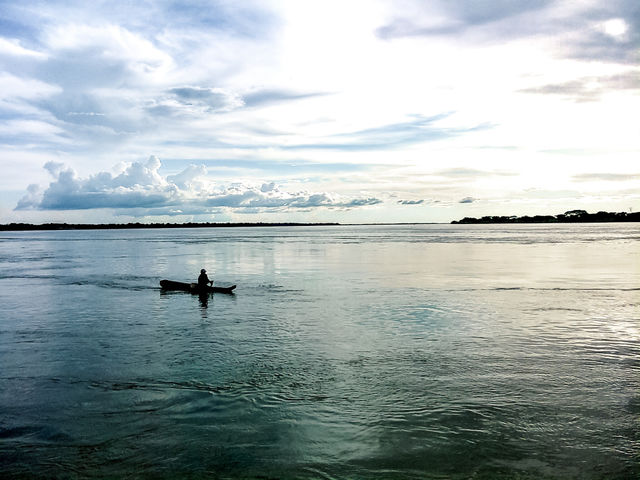 Photograph of a boat passing the orinoco river, taken in Amazonas, Venezuela