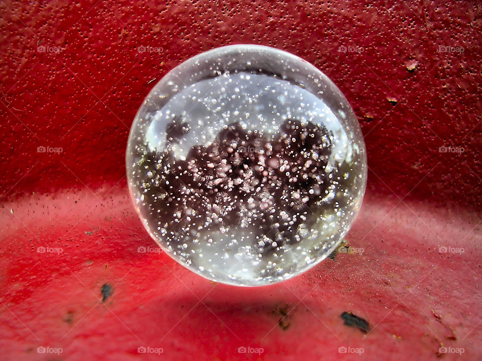 Anti-Gravity Dreams.

Close-up/macro of a clearly marble on red fire hydrant, creating an optical illusion of floating.