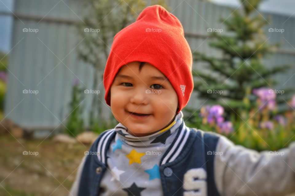 happy child in red cap looking at camera