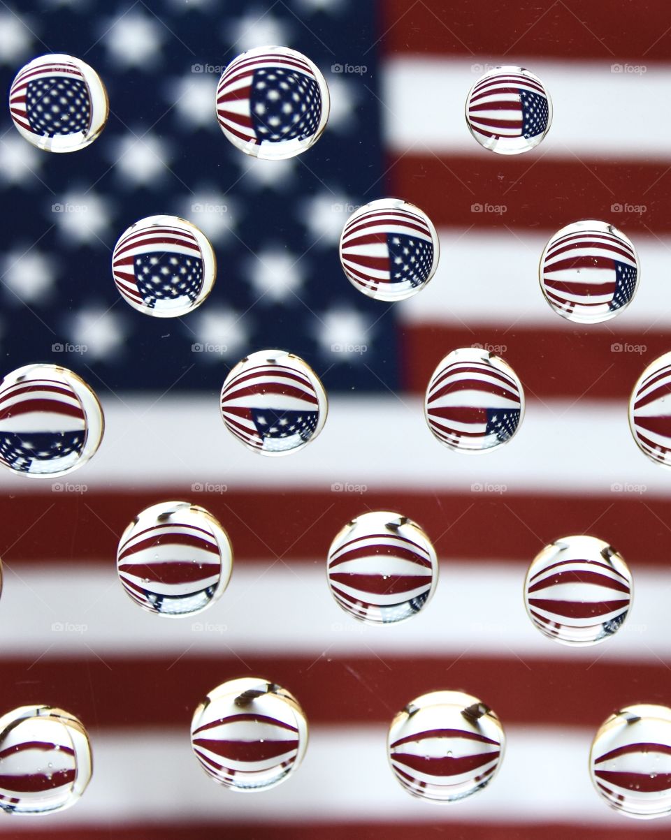 Flat lay still life, American flag reflected into water drops 