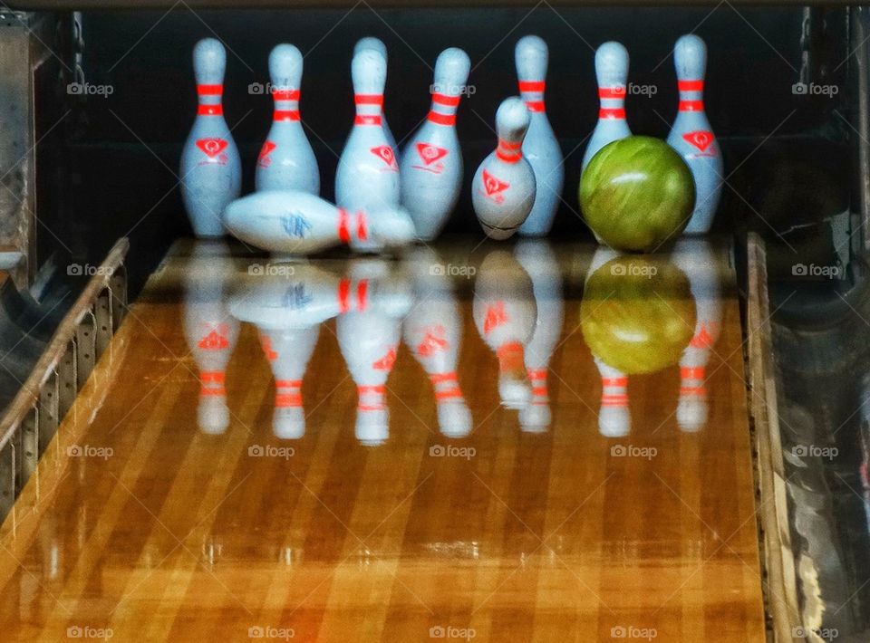 Bowling Pins Set Up For A Strike. Bowling Ball Striking The Pins
