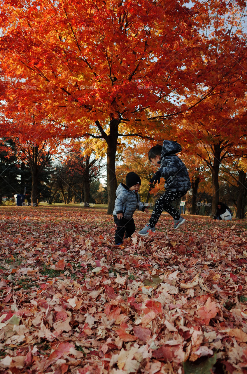 2 kids playing on a nice fall day