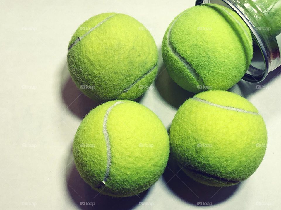 Four used tennis balls 