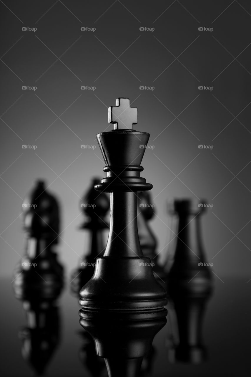 Leadership concept chess king with other pieces