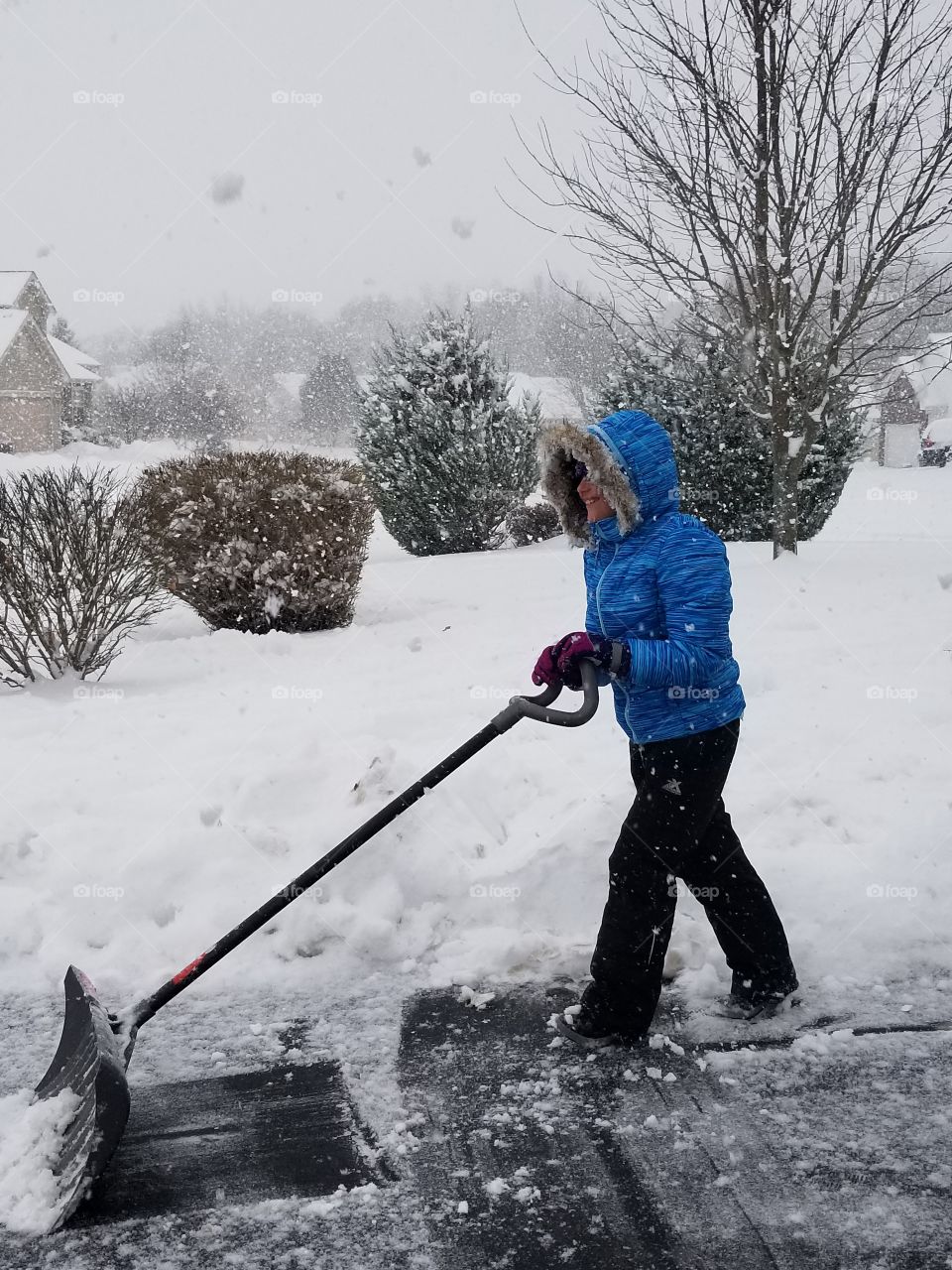 child moving snow during winter storm Bruce