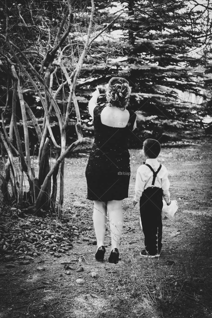 Mother showing son the bird in the tree