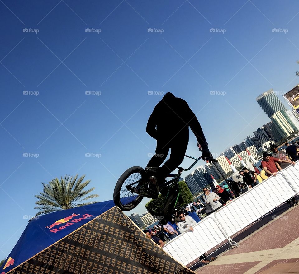 Bicycle drifting, playing with bicycle blue sky background cyclist in air 