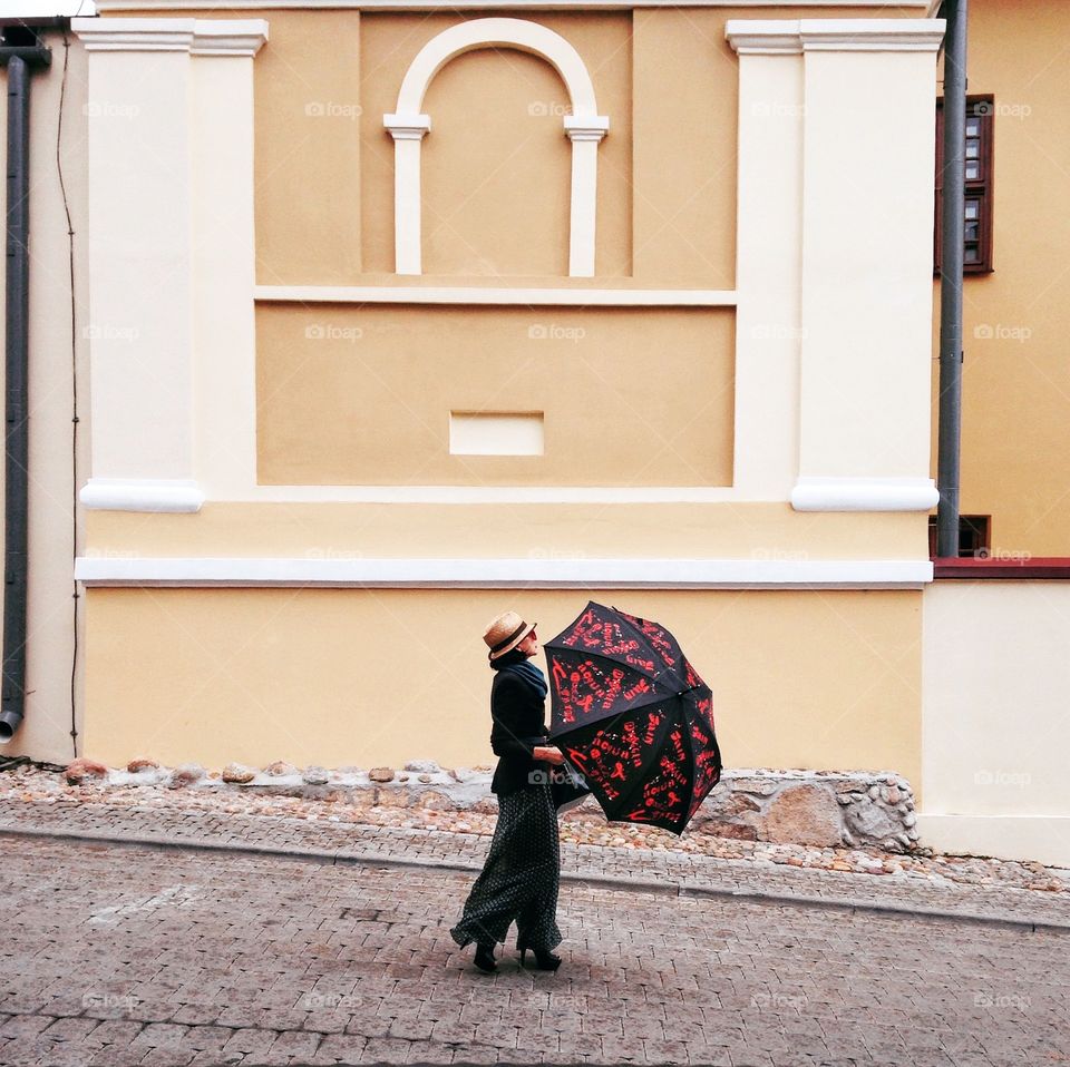 Woman with umbrella walking on the street 