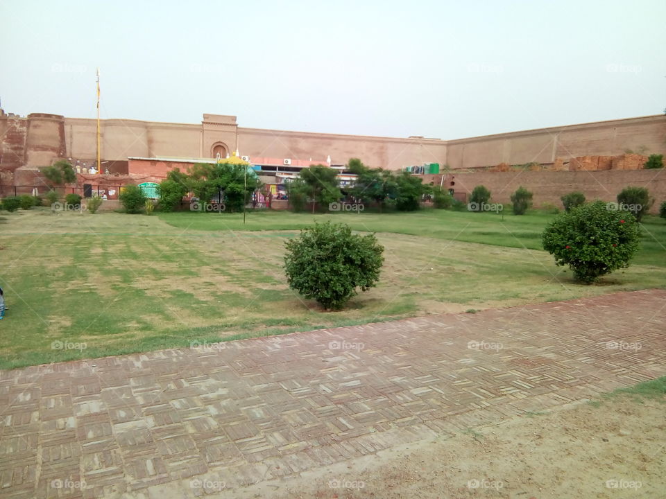 a little boy playing in an ancient fort of Bathinda city- a monument protected by Govt Of India- inner part