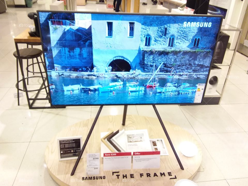 Samsung The Frame Art Mode TV on studio stand freestanding