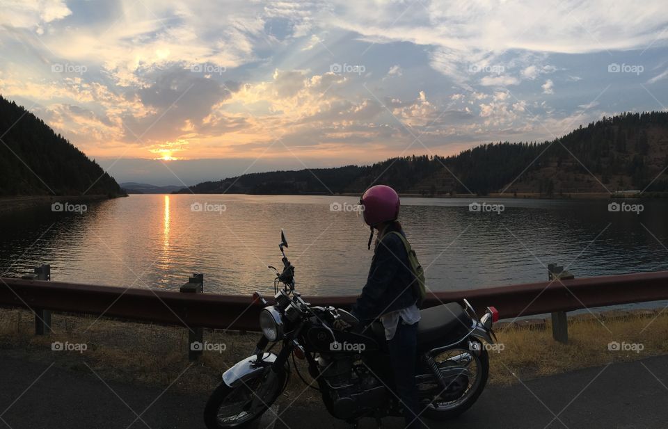 Motorcycle girl enjoying a sunset in Idaho. 