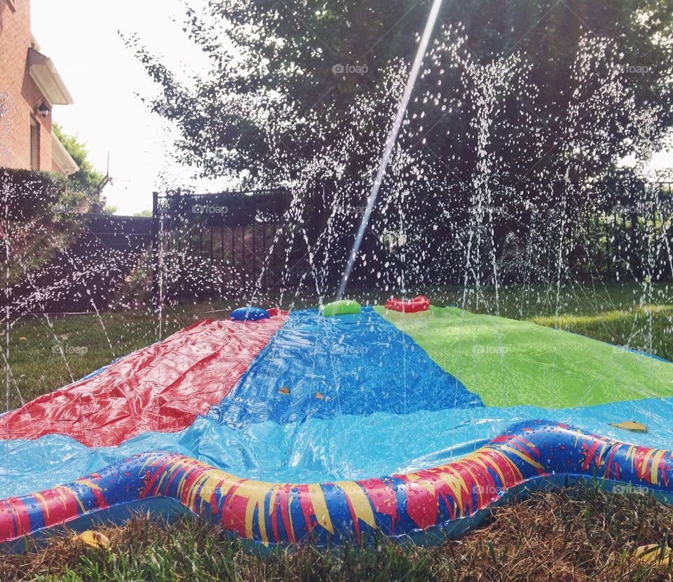 Water slide on grassy field