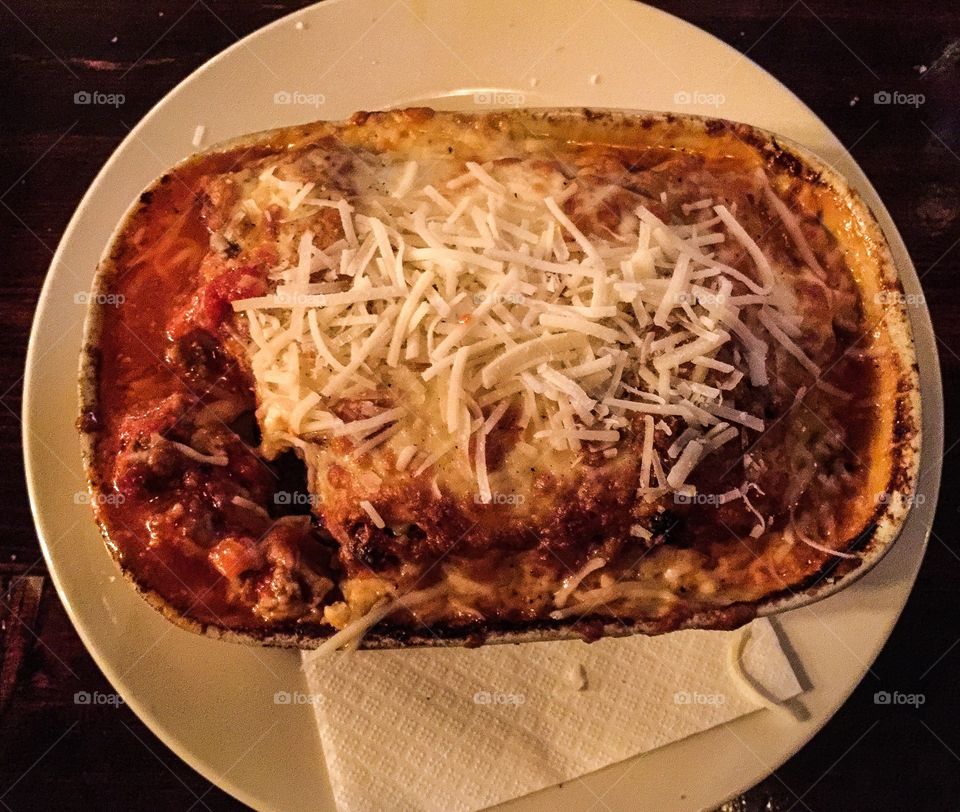Cheesy beef lasagne topped with fresh grated Parmesan cheese; served very hot.