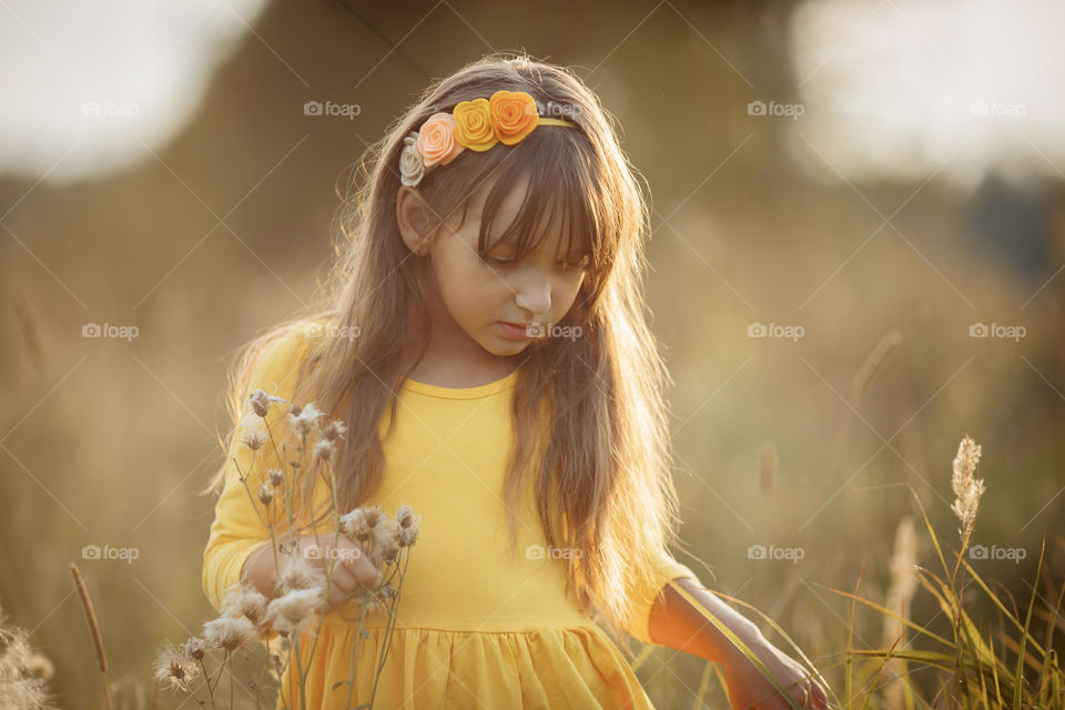 Little girl in yellow dress outdoor portrait 