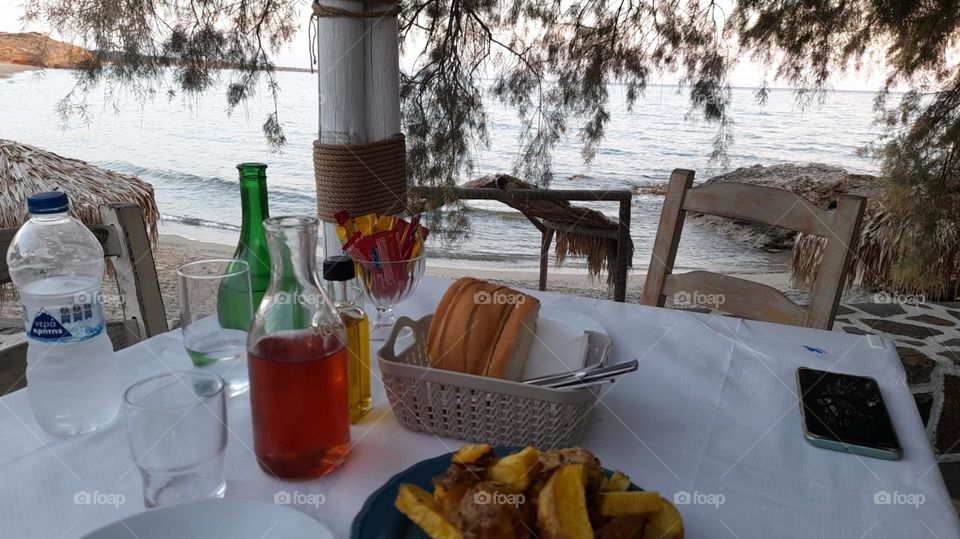 dining outside overlooking beach ocean sand nature bread cafetier wine