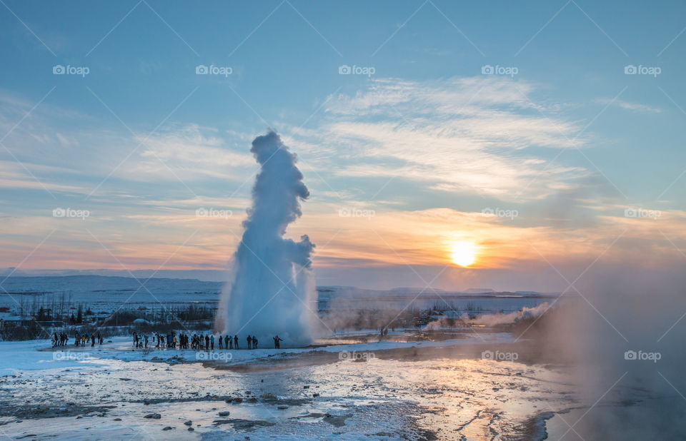 Eruption of a hotspring at sunset