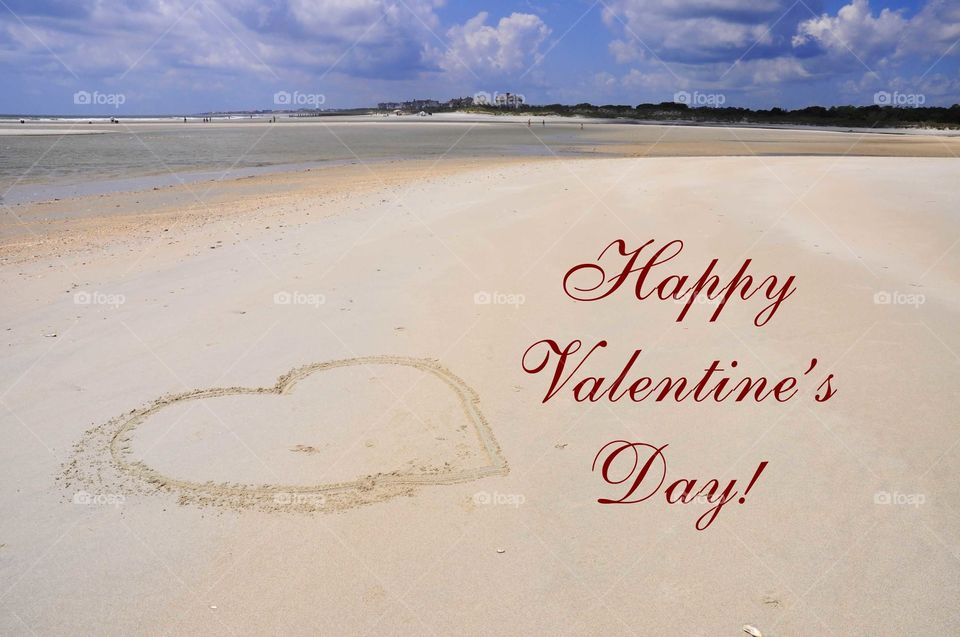 Happy Valentine's Day! Heart drawn on the sand.