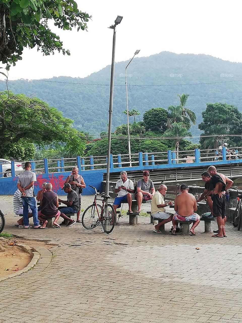 men playing cards near bridge. everyday life Brazil
