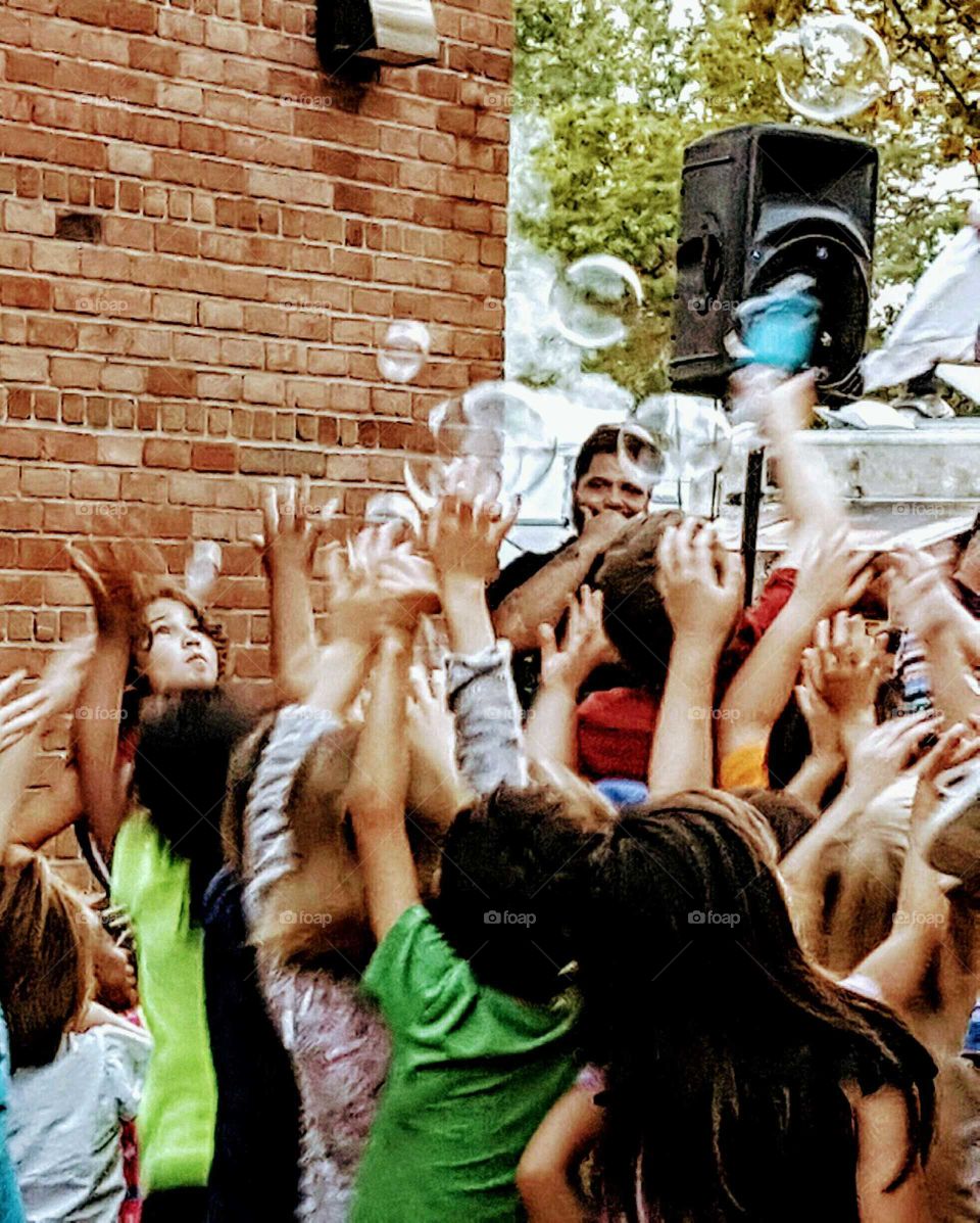 Children Reaching for Bubbles