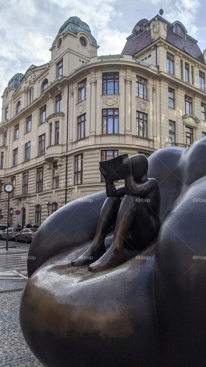 A sculpture of a reader in the center of Prague.