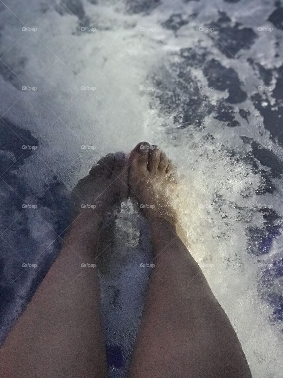 Feet dipped in water
