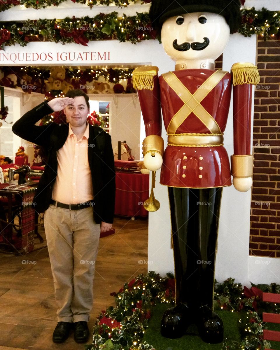 Man saluting near statue in restaurant