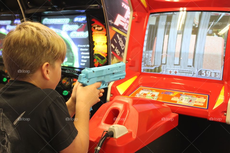 Child playing shooting arcade 