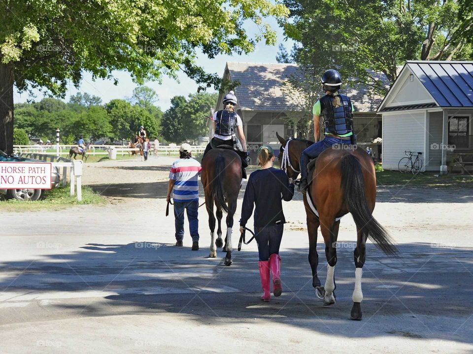 Rear view of girls riding on horse