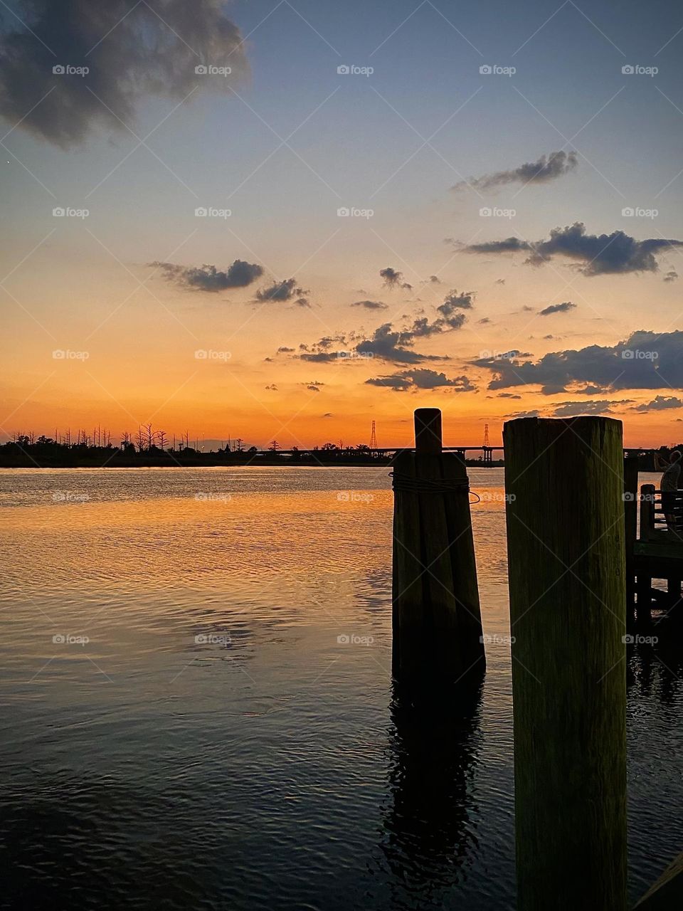 Purple and orange sunset sky on river 