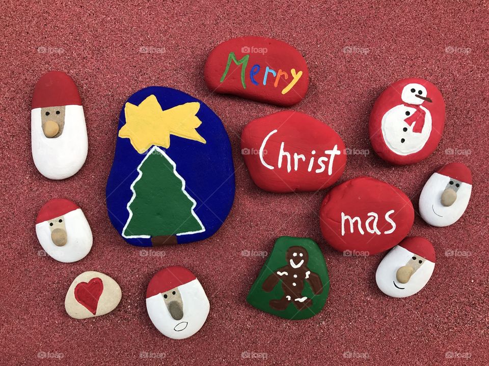 Merry Christmas with many painted stones 