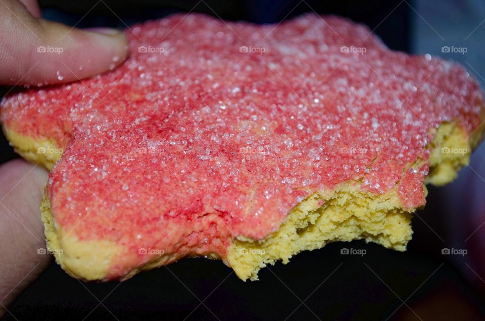 Pink frosted sugar cookie. Just taking a bite out of this delightful pink frosted sugar cookie.