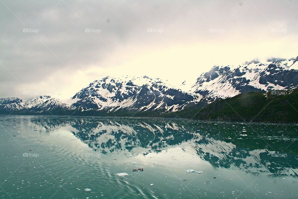 Mountain reflected on frozen lake