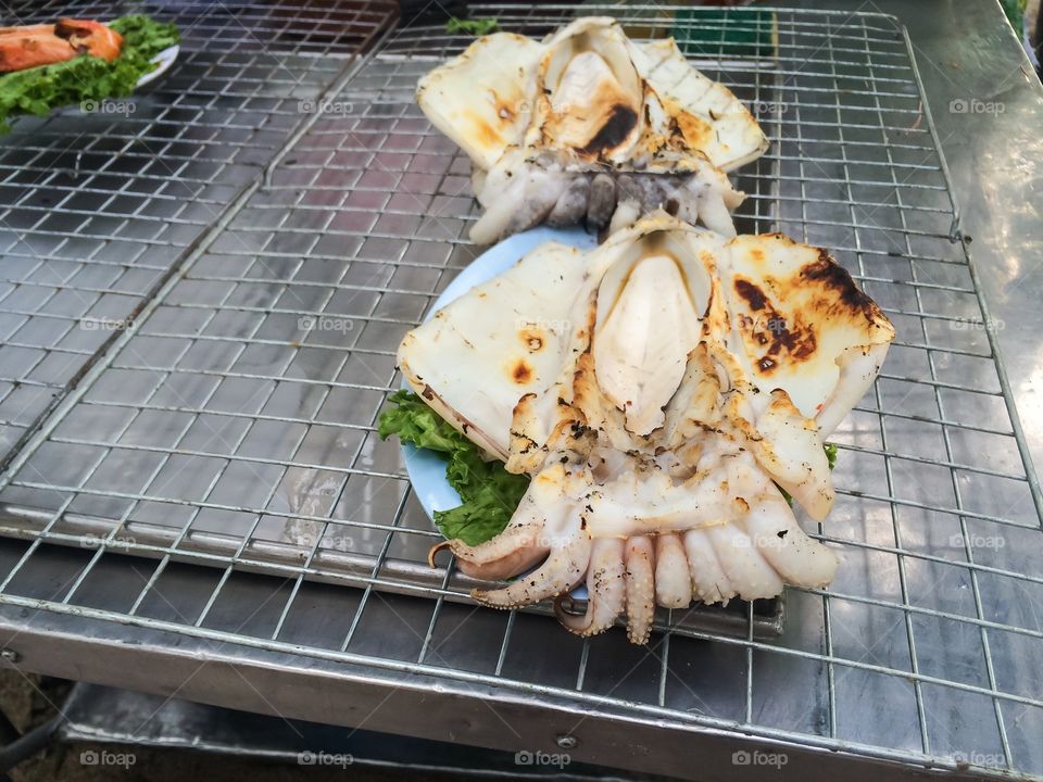 Octopuses grilled street food at seaside 