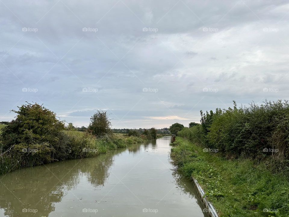 Oxford canal scenery landscape near Daventry past Braunston narrowboat cruise through English countryside water trees horizon sunset