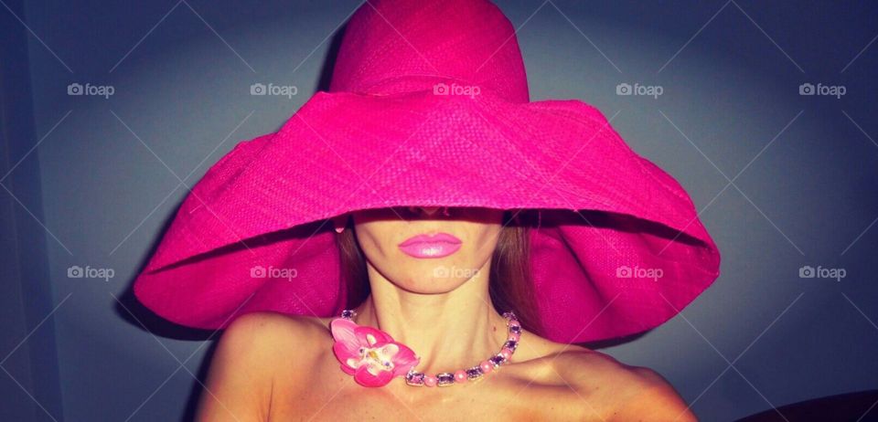Obscured face of a woman in pink hat