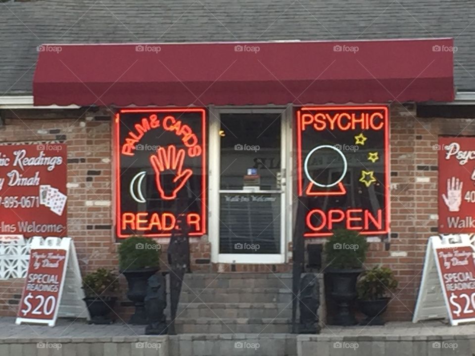 Neon psychic palm reader sign