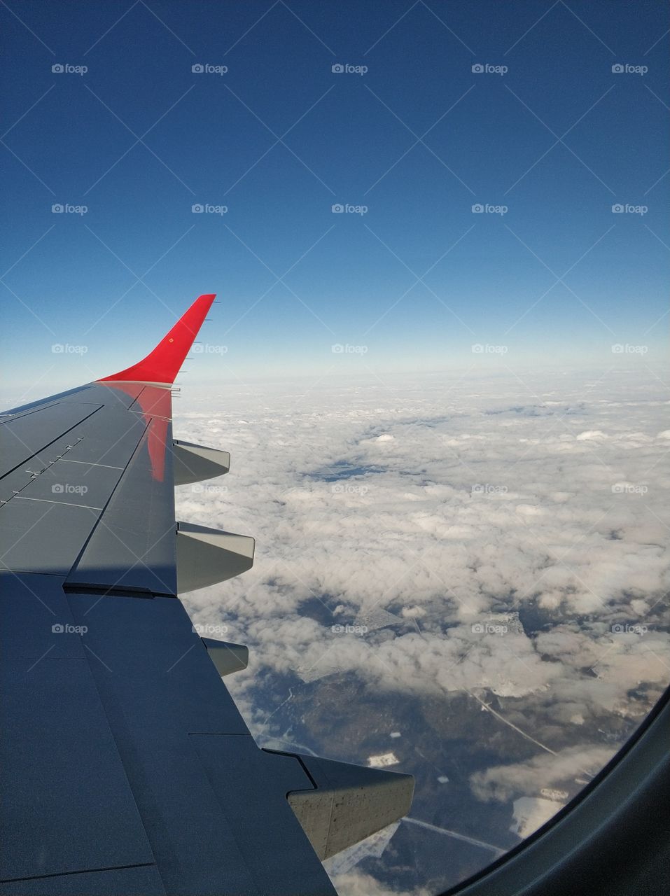 airplane wing in the sky above the clouds