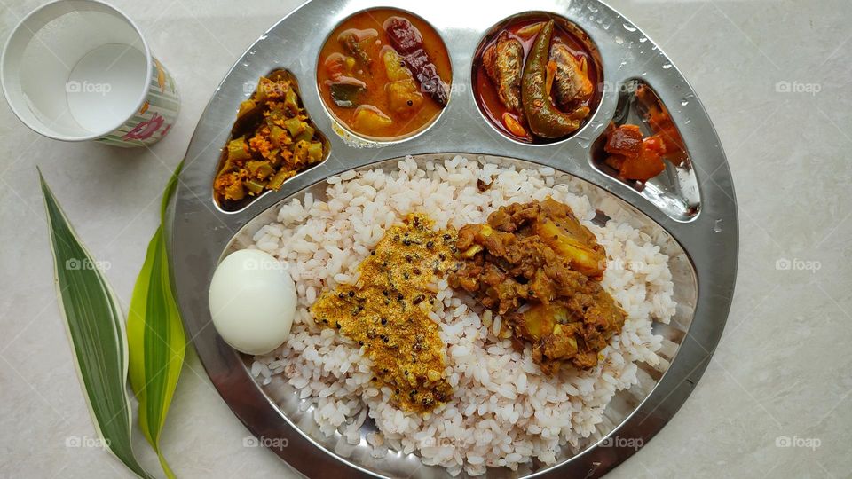 Healthy and tasty Indian Meal, Beautiful presentation of Indian food, spicy foods, vegetarian and non-vegetarian food, Rice Thali, Egg, best food, tasty foods, fish curry, sambar, lemon pickle