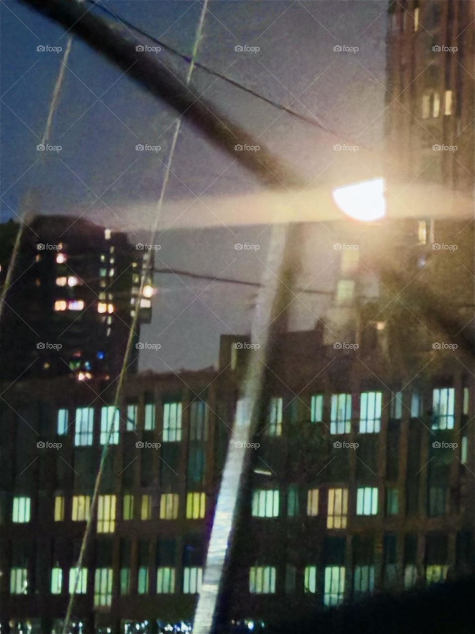 This beautiful nighttime impression with bright moonlight comes to us from “Newtown Creek” by the “Pulaski Bridge” in LIC, Queens looking across the water of the “East River” onto “Greenpoint”, Brooklyn. 2023. Hypnotic Productions