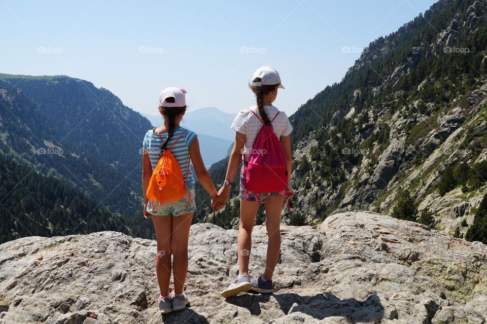 Two girls at a viewpoint in the mountains