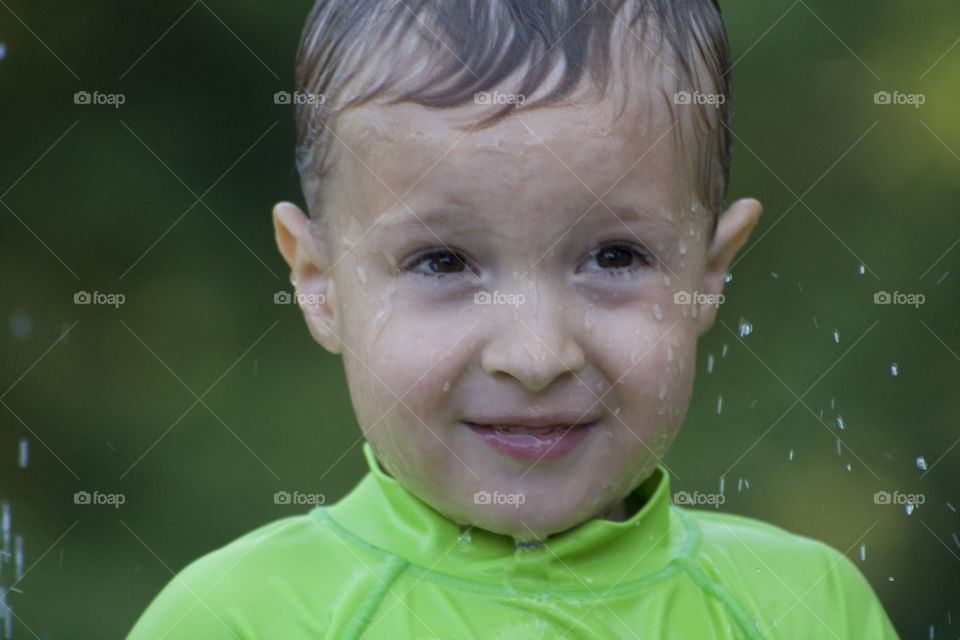 Little boy splashing in water 