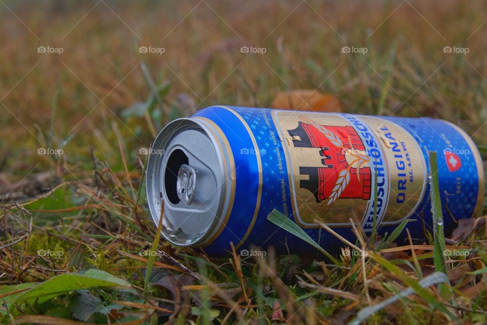 Empty Beer Can On Wet Grass