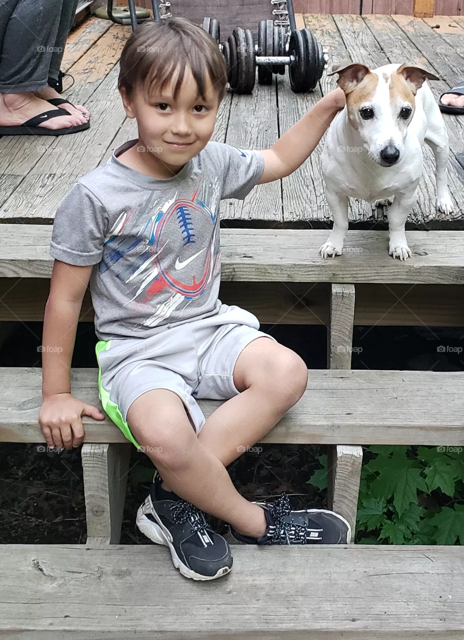 Little Boy Sitting With Jack Russell Terrier Dog