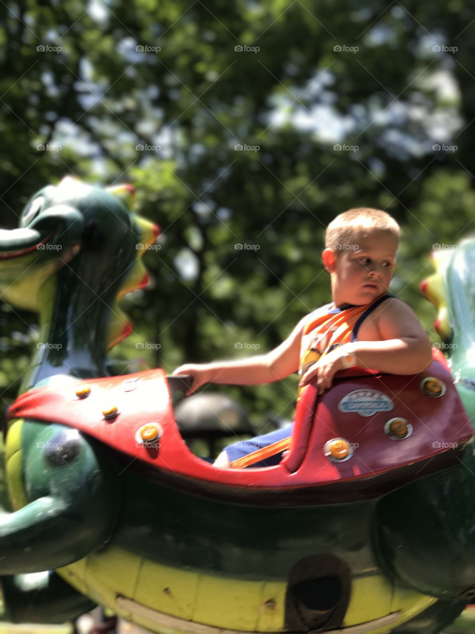 Little boy having fun in amusement park
