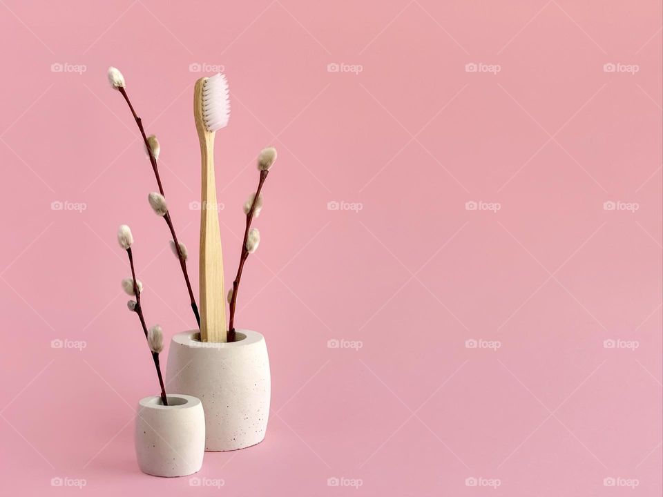 Bamboo toothbrush on pink, spring plant