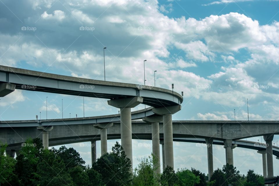 Art fully composed shot of highway overpasses against a cloudy sky on a beautiful spring day.