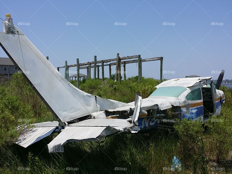 Pilot Error. Abandoned wrecked small plane on beach.