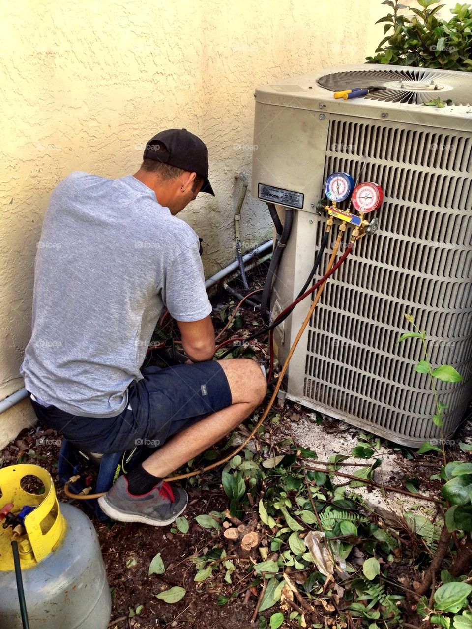 Man repairing air conditioning in a house